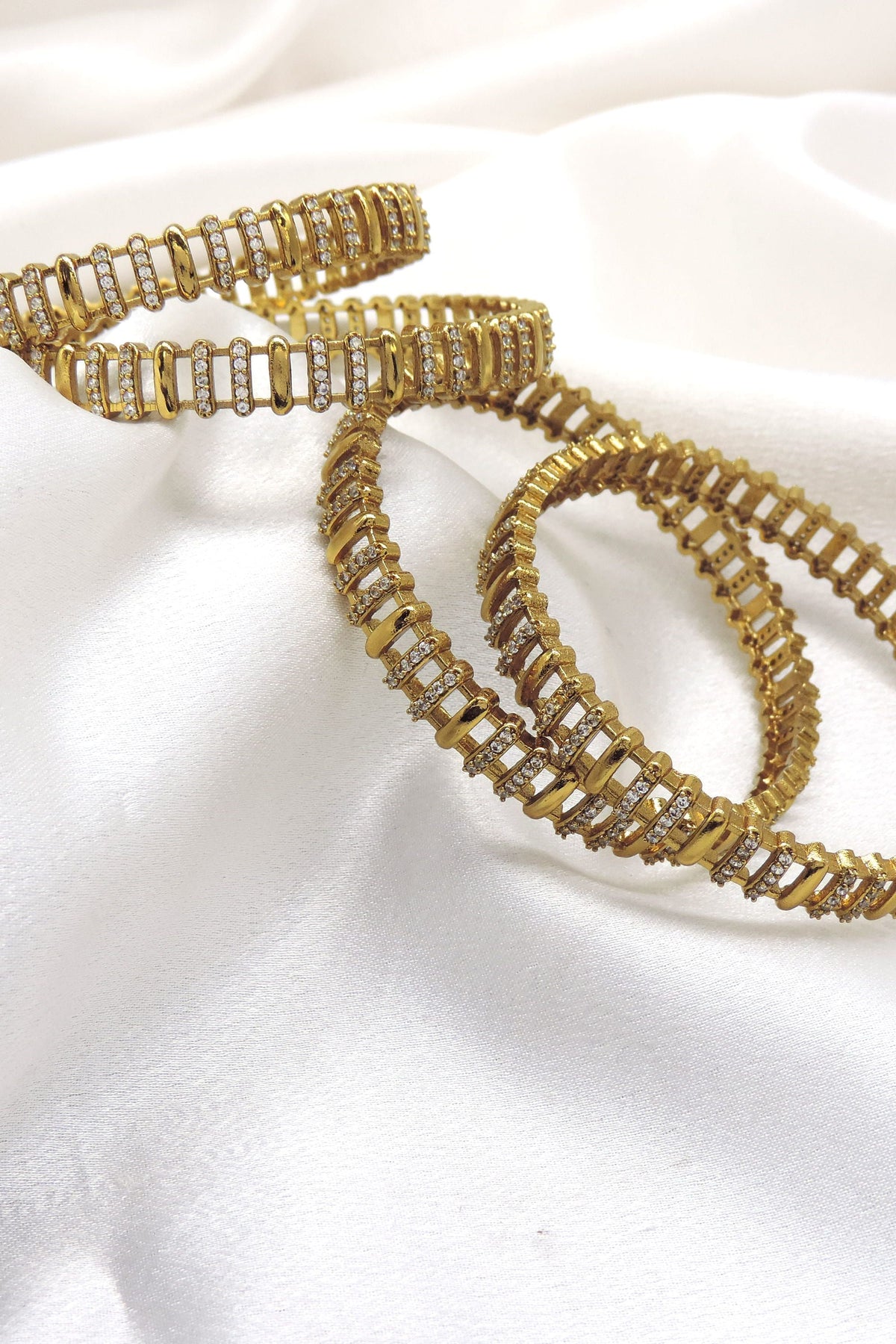 Gold plated CZ AD bangle set with intricate linked detailing by joyrias