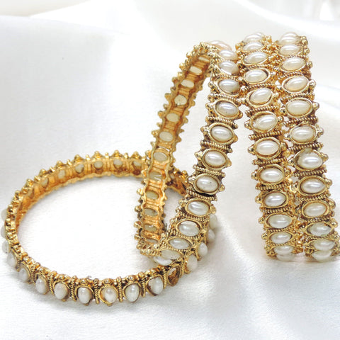 Gold-toned polki white pearl bangle set with intricate detailing by joyrias