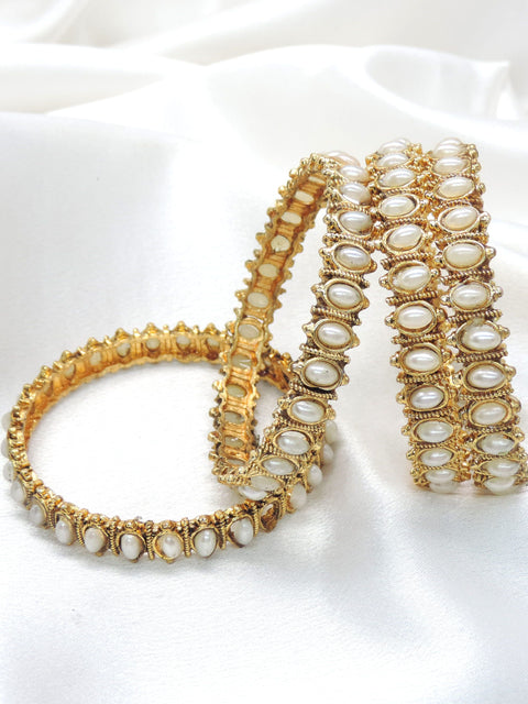 Gold-toned polki white pearl bangle set with intricate detailing by joyrias