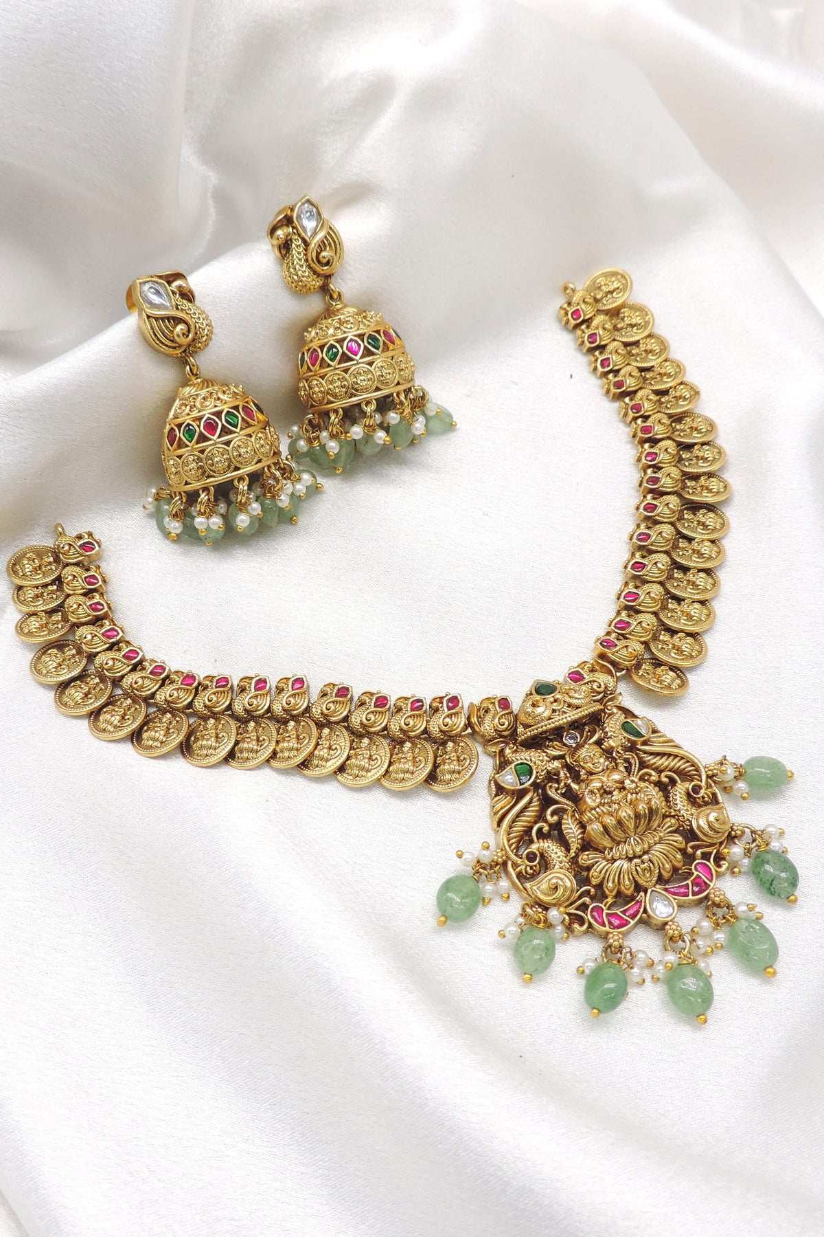 Gold plated ruby emerald temple necklace set with coin motifs and jhumka earrings by joyrias