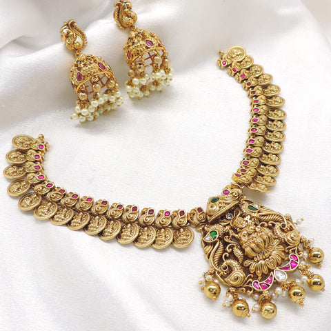 Ruby emerald gold plated temple necklace set with intricate coin motifs and jhumka earrings by joyrias