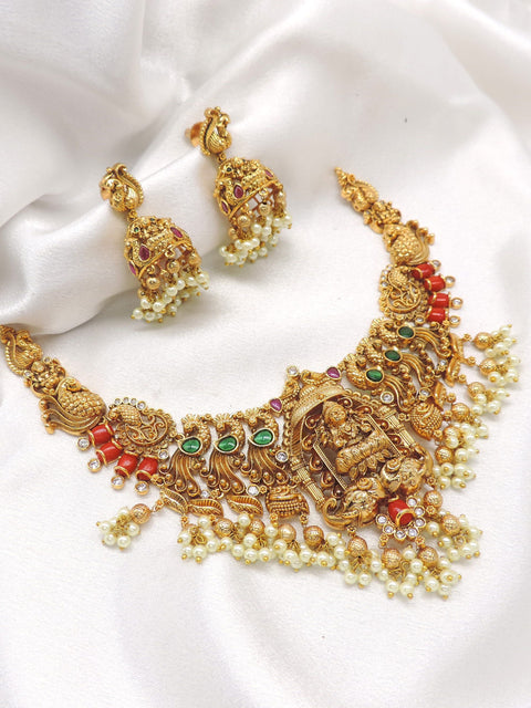 Ruby emerald gold plated traditional temple choker set with pearl drops and matching jhumka earrings by joyrias