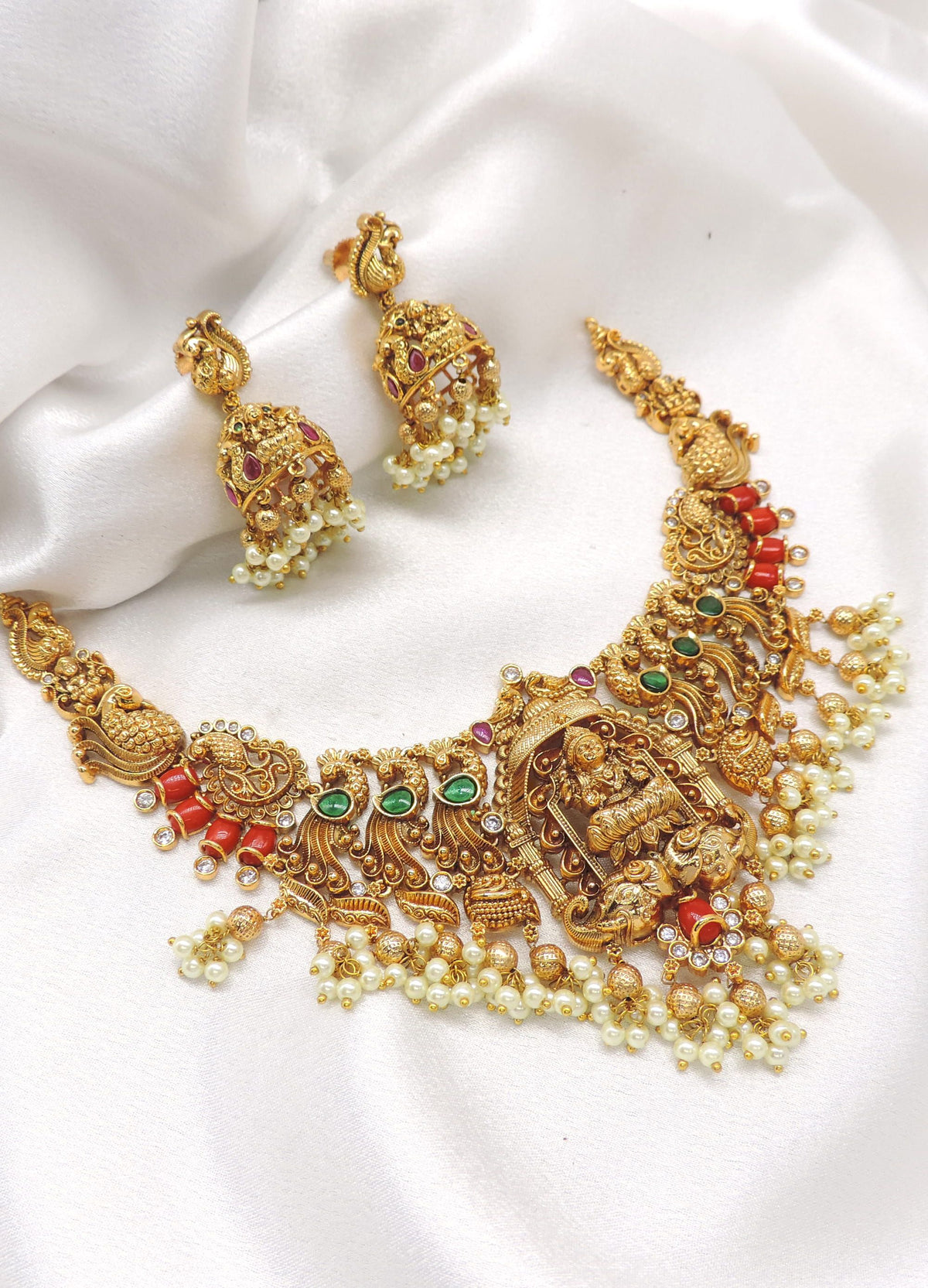Ruby emerald gold plated traditional temple choker set with pearl drops and matching jhumka earrings by joyrias