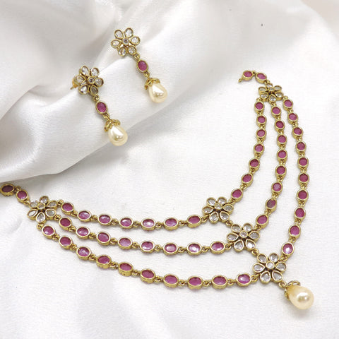 Pink ruby Kundan floral layered necklace set with pearl drops and matching earrings by joyrias