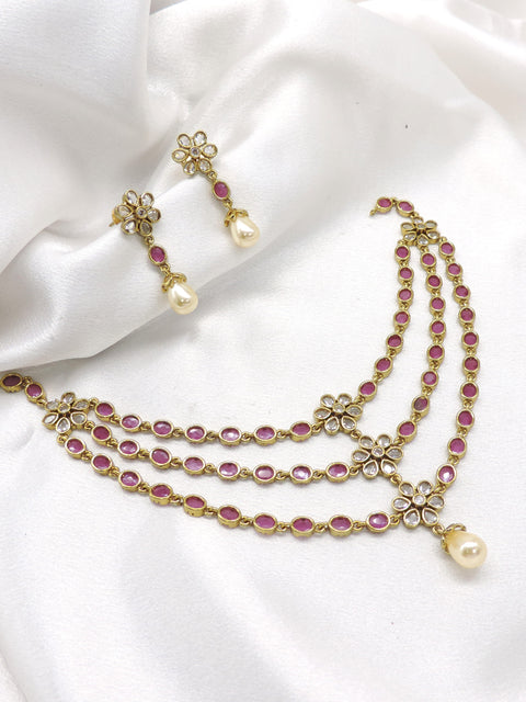 Pink ruby Kundan floral layered necklace set with pearl drops and matching earrings by joyrias