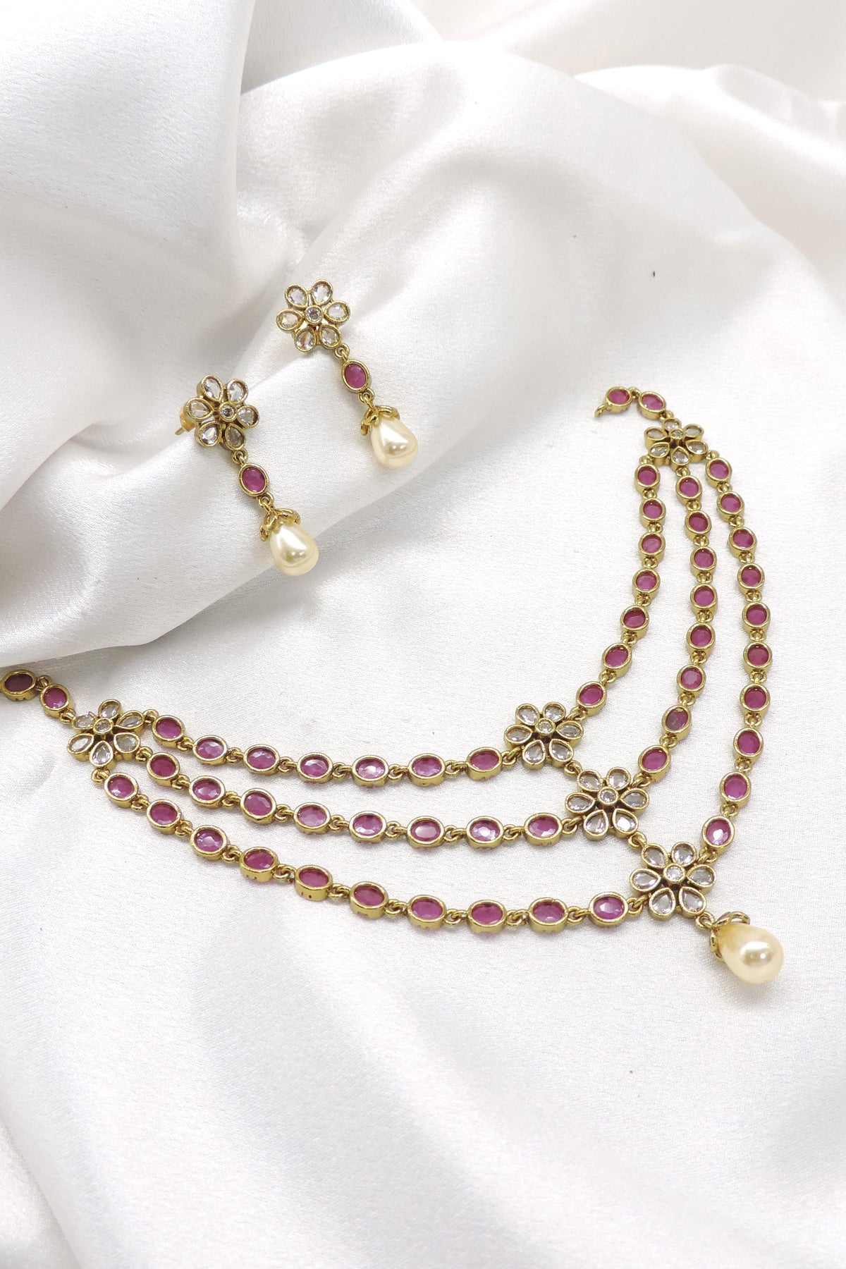 Pink ruby Kundan floral layered necklace set with pearl drops and matching earrings by joyrias