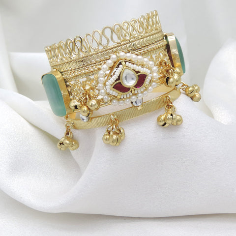Gold-toned green stone pearl cuff bracelet with traditional detailing and dangling charms by joyrias