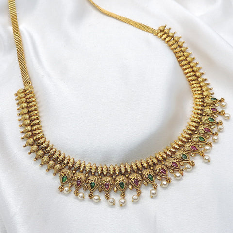 Gold-plated ruby emerald temple waistbelt with pearl drops and intricate motifs by joyrias