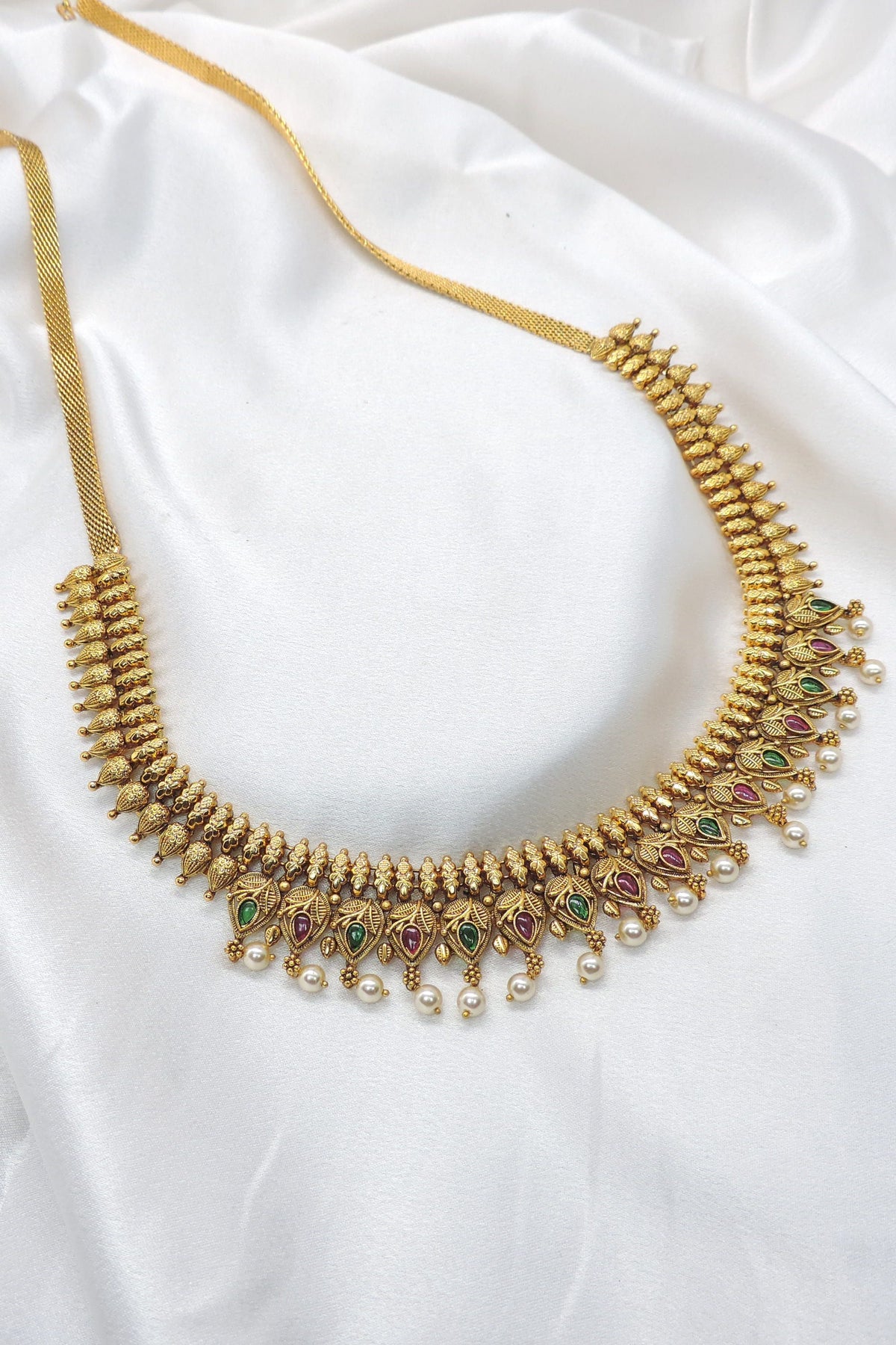 Gold-plated ruby emerald temple waistbelt with pearl drops and intricate motifs by joyrias