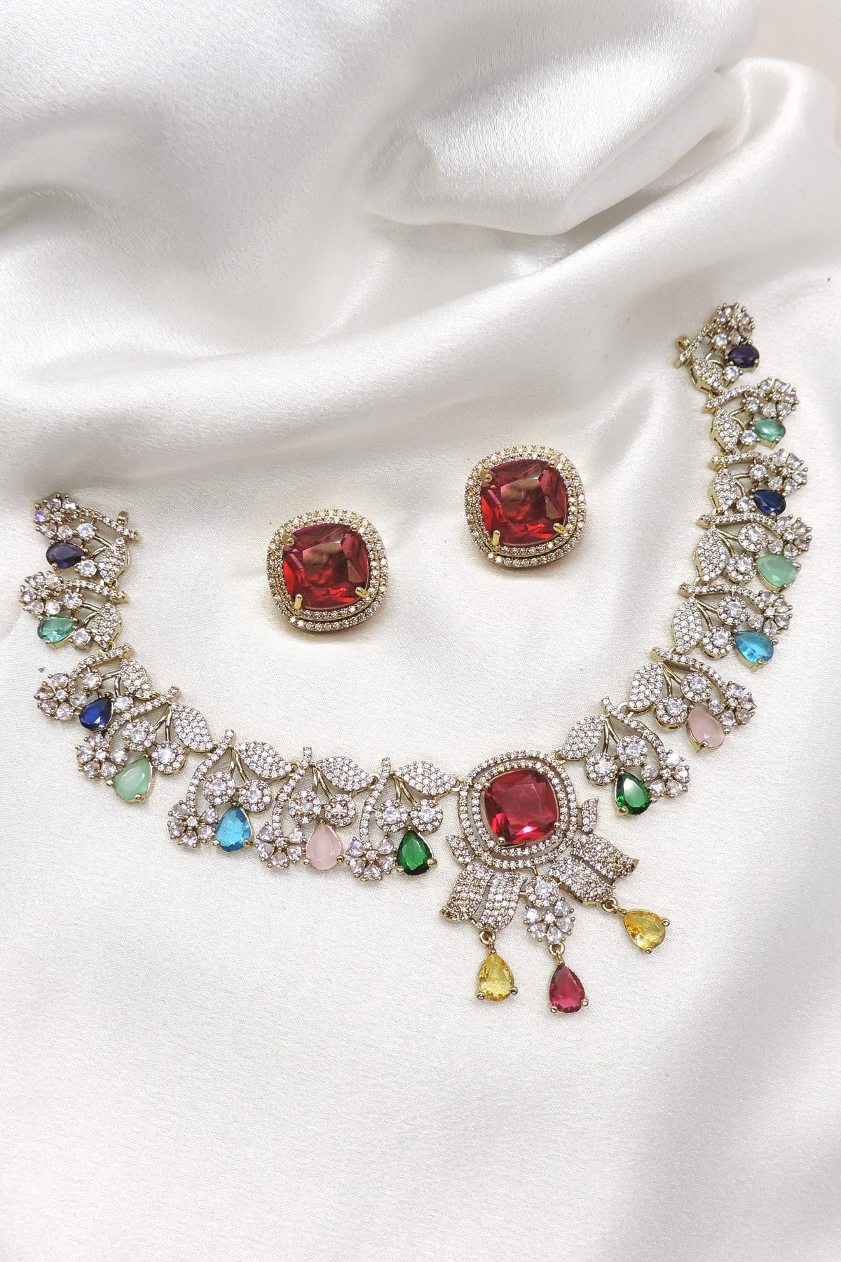 Ruby multicolor CZ necklace set with floral accents and matching earrings by joyrias