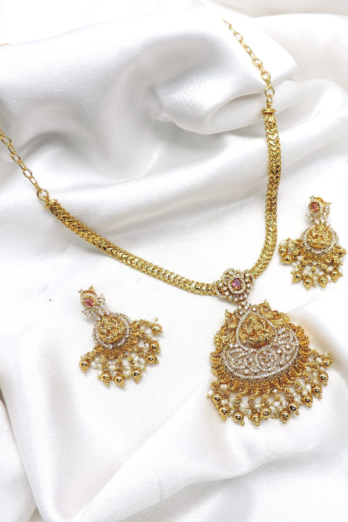 Traditional gold plated ruby CZ AD temple necklace set with ornate pendant, pearl drops and matching earrings by joyrias