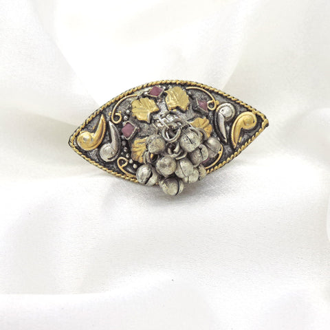 Oxidised ring with gold accents, red stones and textured bead detailing from joyrias