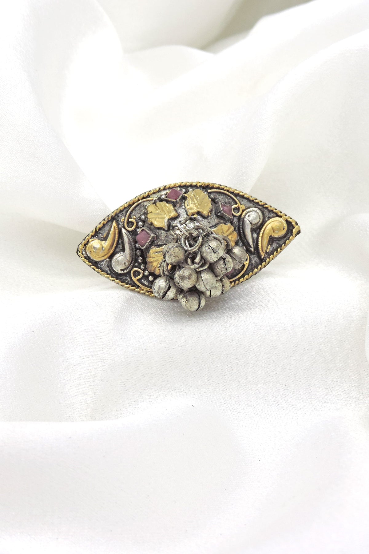 Oxidised ring with gold accents, red stones and textured bead detailing from joyrias