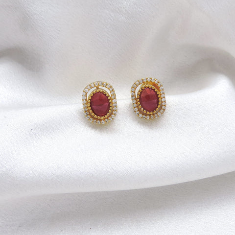 Ruby oval CZ AD stud earrings with gold-tone detailing by joyrias