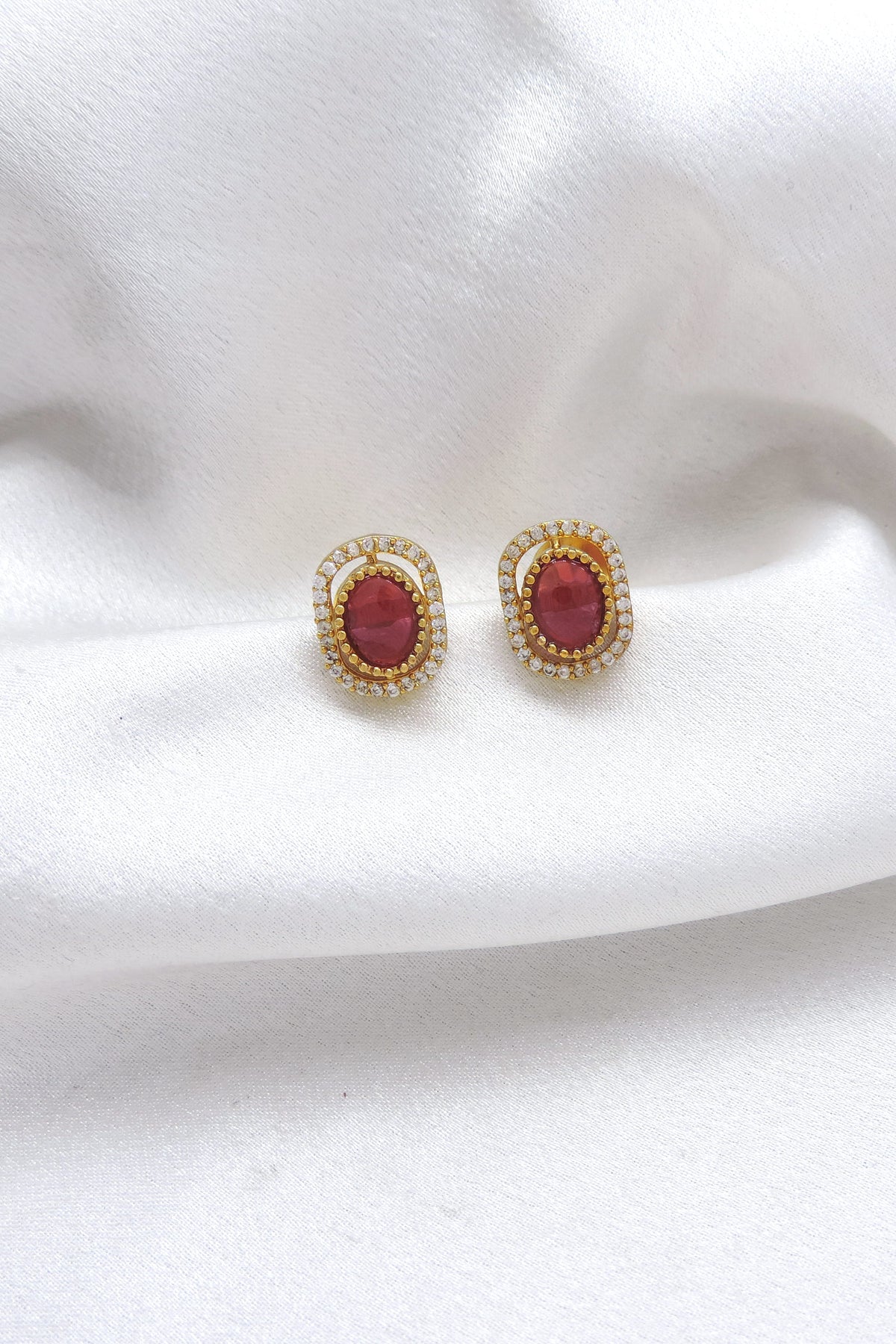 Ruby oval CZ AD stud earrings with gold-tone detailing by joyrias