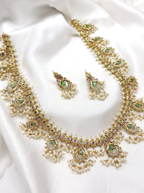 Elegant ruby emerald CZ AD temple necklace set with traditional detailing by joyrias