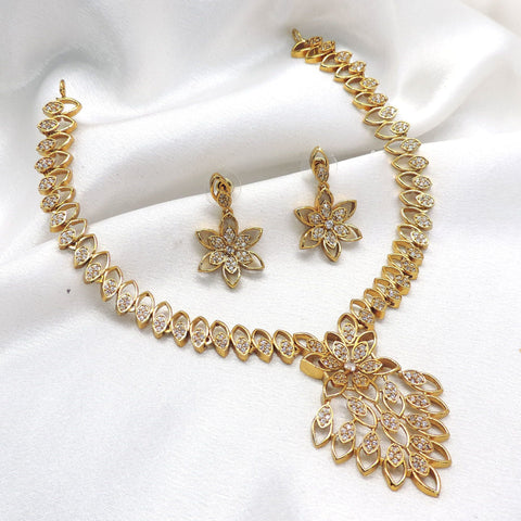 Gold tone floral CZ AD necklace set with leaf-inspired pendant and matching earrings by joyrias