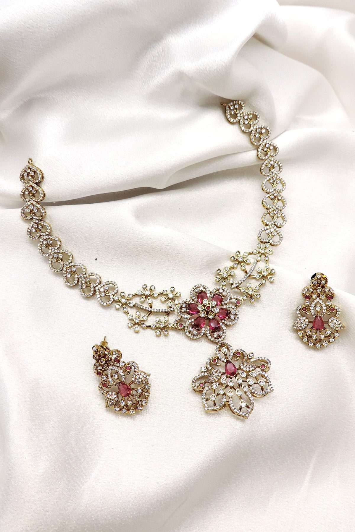 Pink floral CZ AD necklace set with matching earrings and gold-tone detailing by joyrias