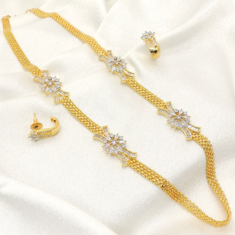Gold plated floral AD chain necklace set with matching earrings, featuring floral motifs and sparkling AD stones, displayed on satin background.