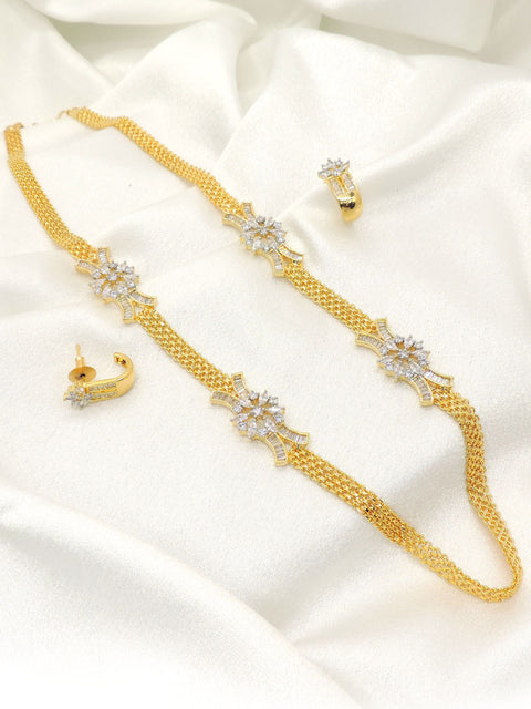 Gold plated floral AD chain necklace set with matching earrings, featuring floral motifs and sparkling AD stones, displayed on satin background.