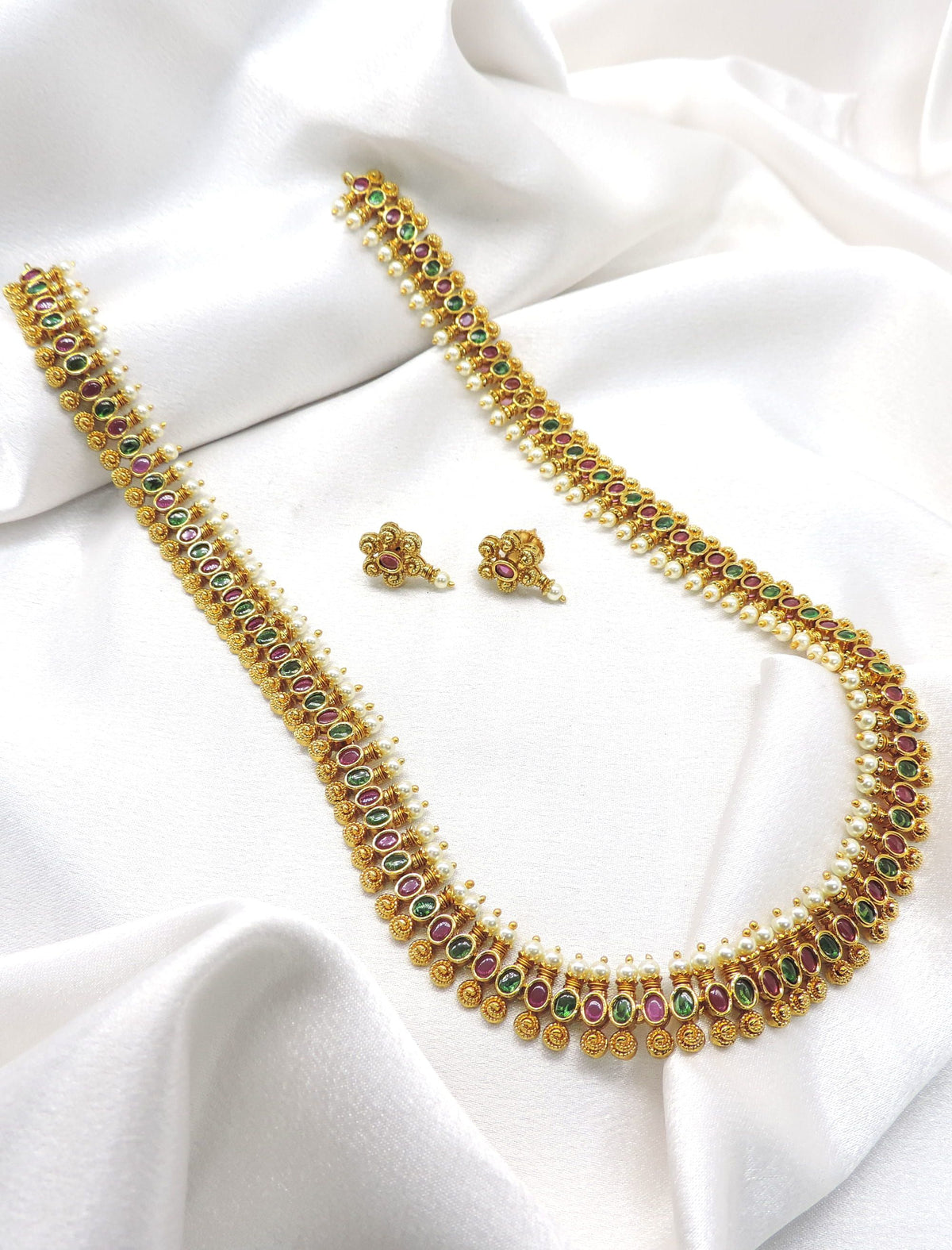 Traditional classic gold-toned temple long necklace set with ruby and green stones and matching earrings by joyrias