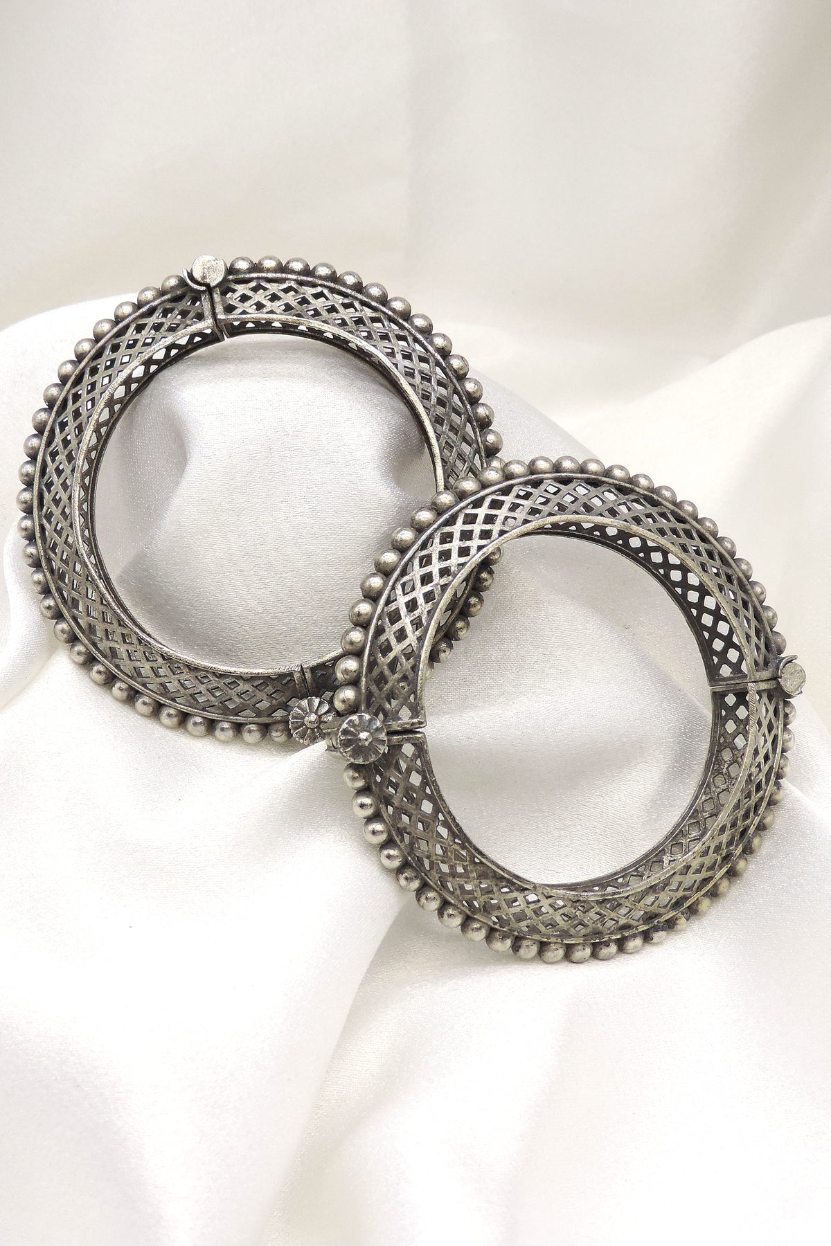 Oxidized silver lattice beaded bangle set with intricate openwork and floral detailing by joyrias