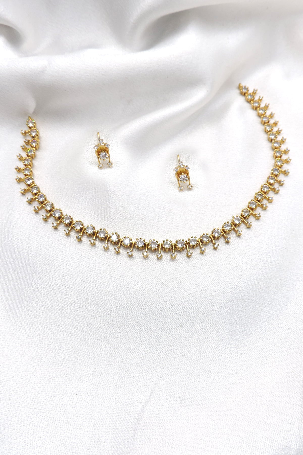 Gold-toned CZ dangling link necklace set with matching earrings by joyrias