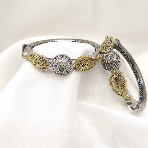 Oxidized dual-tone gold silver floral bangle set with green stone detailing by joyrias