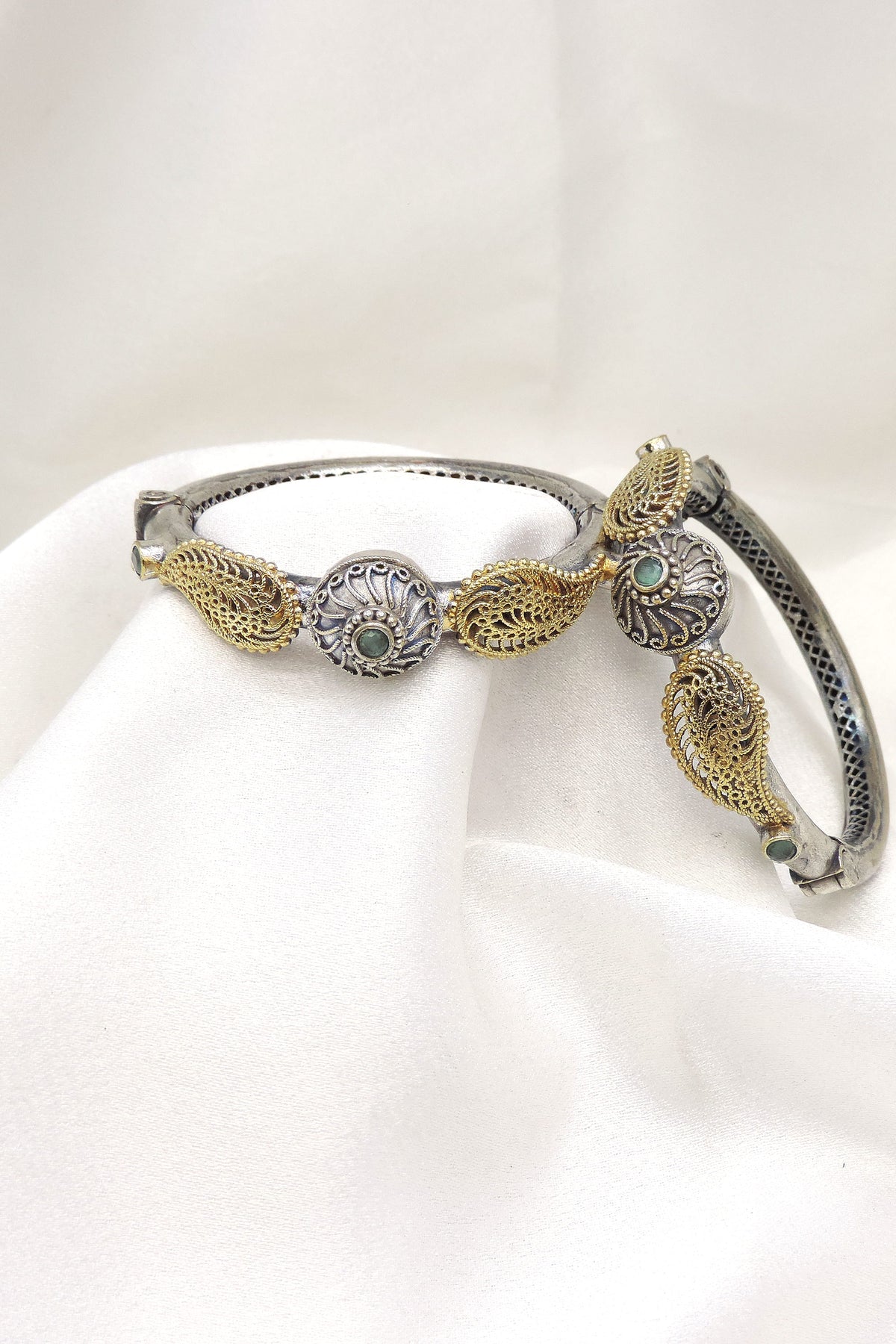 Oxidized dual-tone gold silver floral bangle set with green stone detailing by joyrias