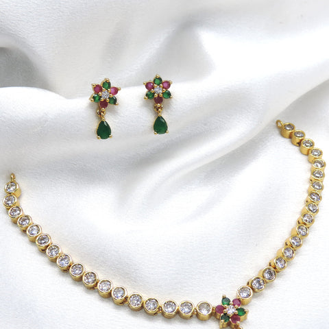 Gold-toned graduated tennis necklace with emerald floral pendant and matching drop earrings by joyrias
