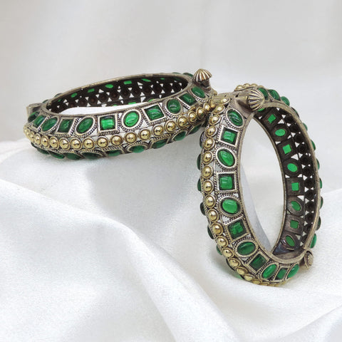 Oxidized dual-tone green stone bangle set with intricate openwork and gold-toned bead detailing by joyrias