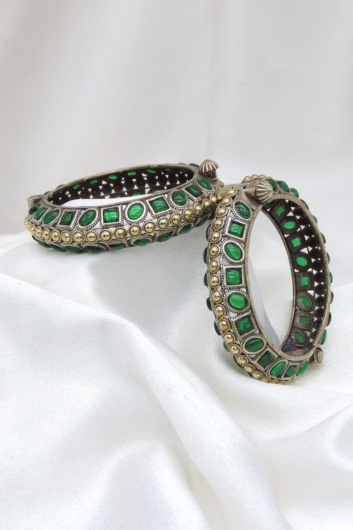 Oxidized dual-tone green stone bangle set with intricate openwork and gold-toned bead detailing by joyrias