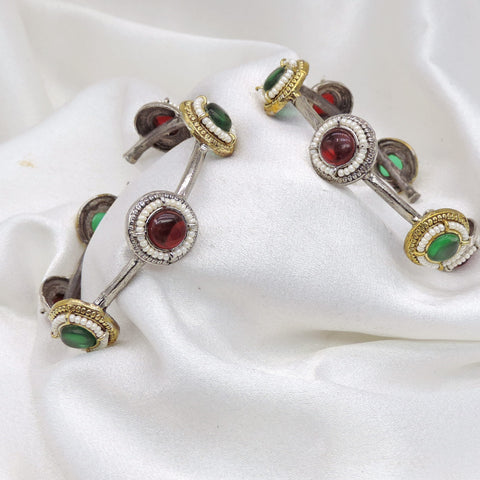 Oxidized dual-tone gold silver bangle set with green and red stone detailing by joyrias