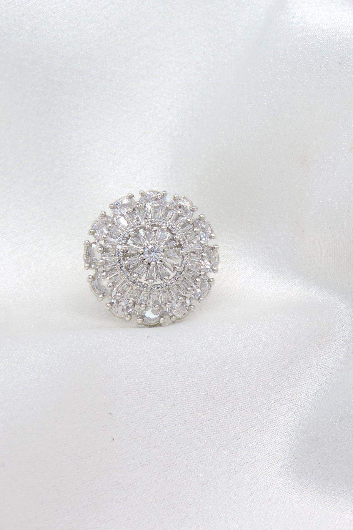Dazzling round CZ ring with intricate baguette detailing by joyrias