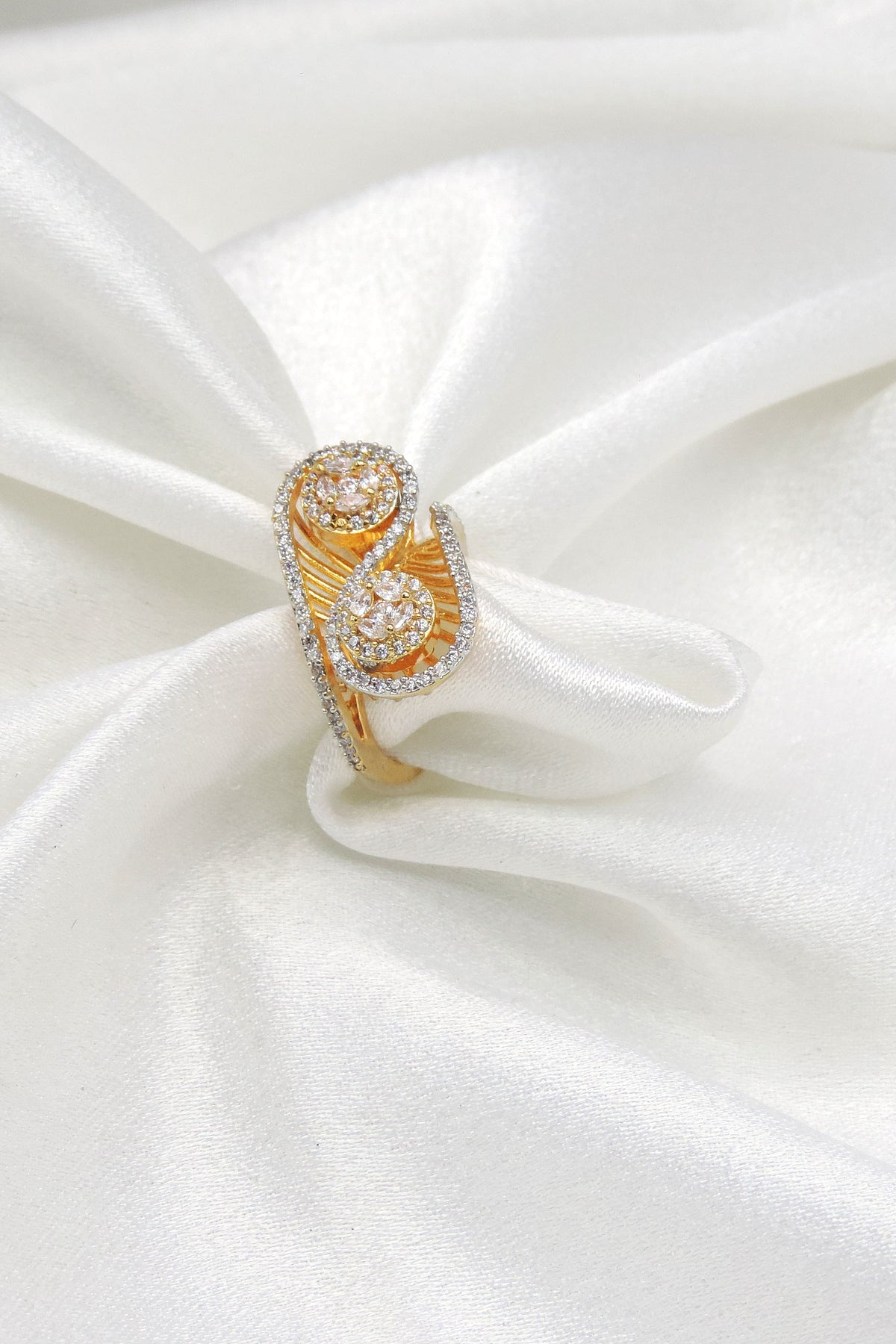 Opulent gold-toned AD double band ring with intricate circular detailing by joyrias