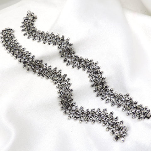 Oxidized silver floral ghungroo anklet with intricate geometric detailing and dangling bell charms by joyrias