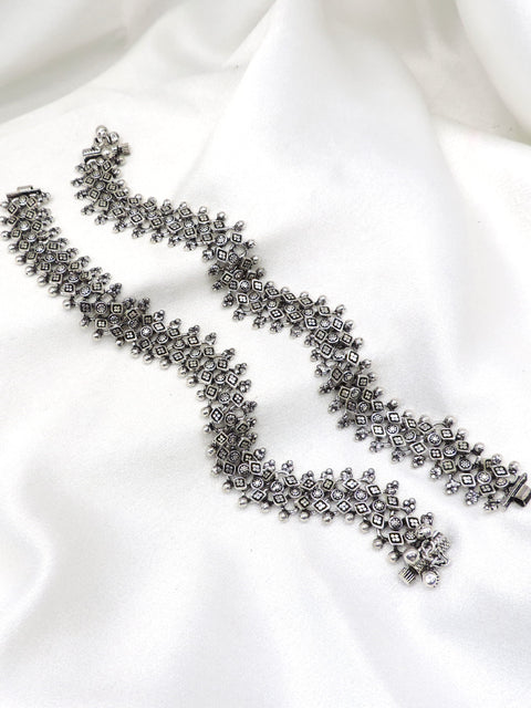 Oxidized silver floral ghungroo anklet with intricate geometric detailing and dangling bell charms by joyrias