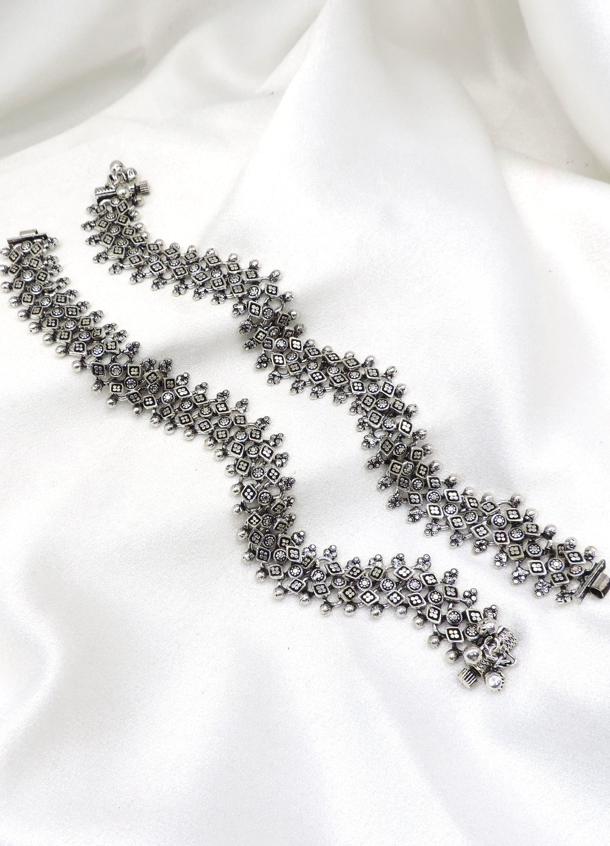 Oxidized silver floral ghungroo anklet with intricate geometric detailing and dangling bell charms by joyrias