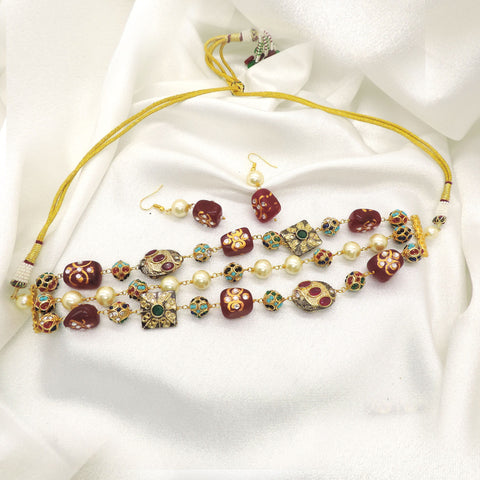 Traditional red and green bead choker set with pearl accents and matching earrings