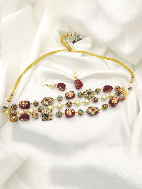 Traditional red and green bead choker set with pearl accents and matching earrings