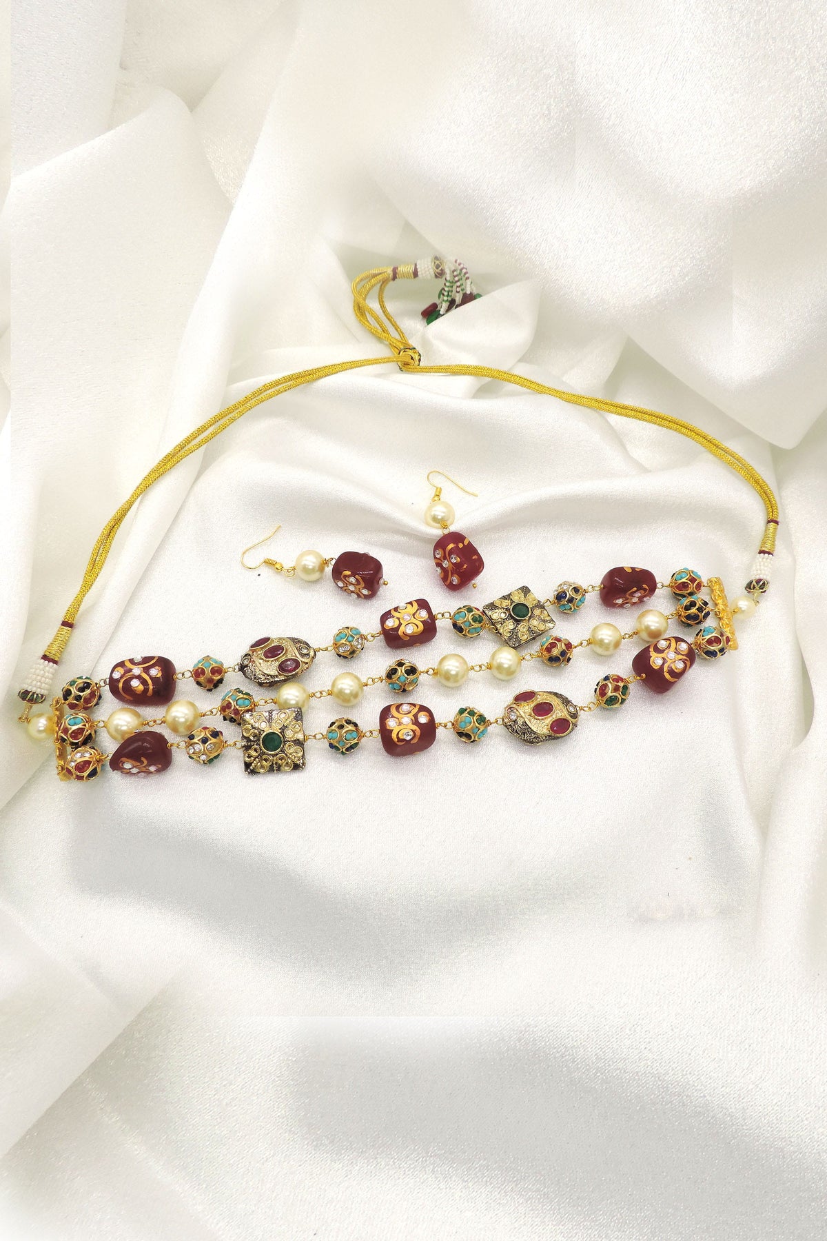 Traditional red and green bead choker set with pearl accents and matching earrings