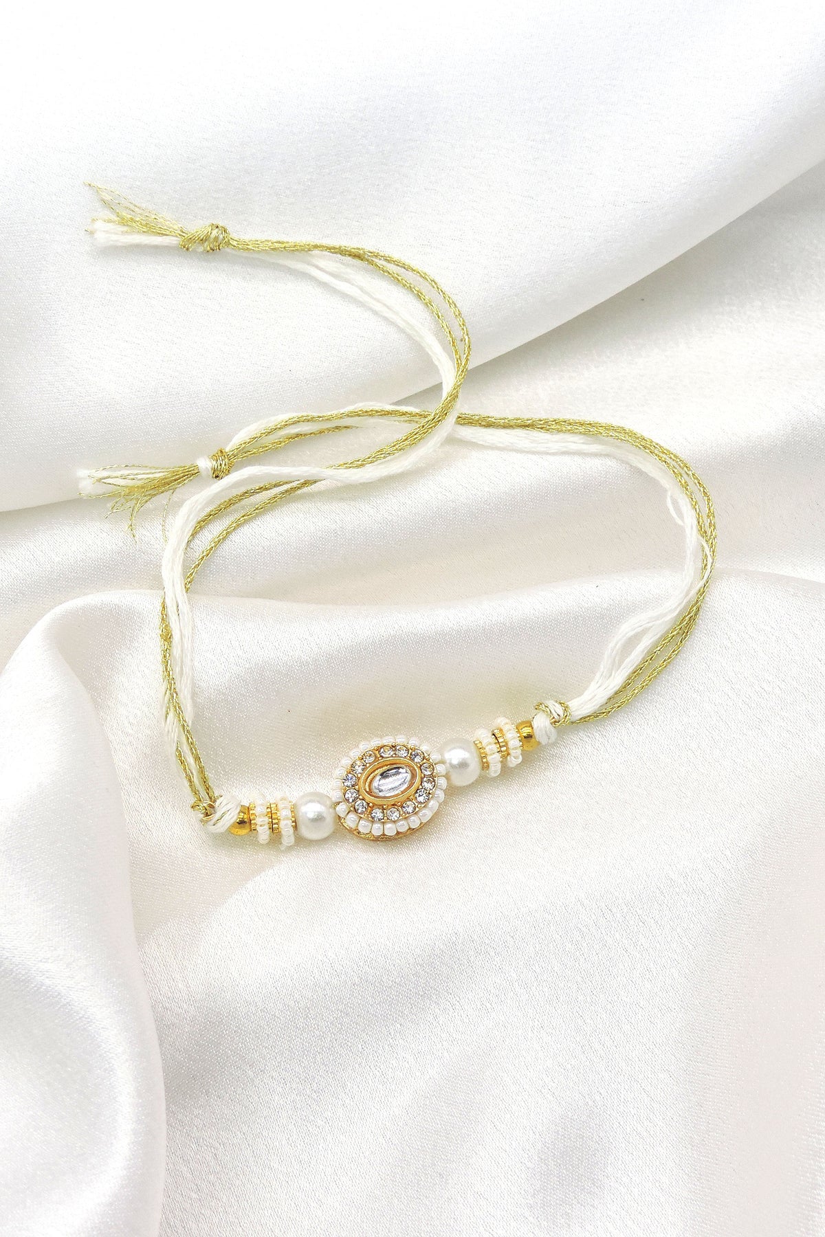 Pearl kundan rakhi by Joyrias