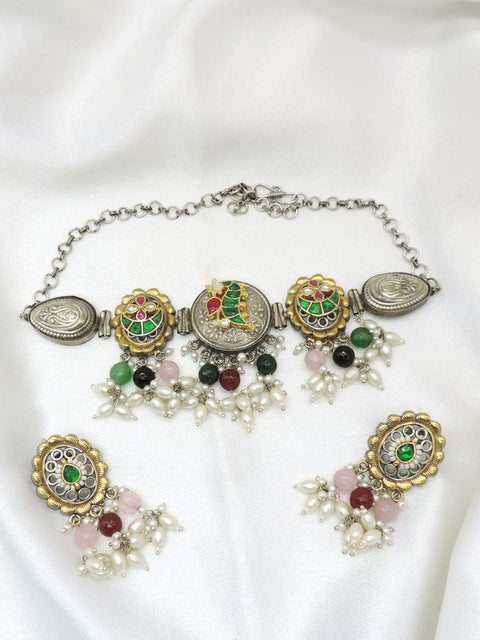 Oxidized dual-tone multicolor meenakari necklace set with pearl detailing and matching earrings by joyrias