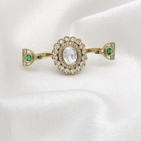 Distinctive CZ green multifinger ring with gold-toned detailing by joyrias