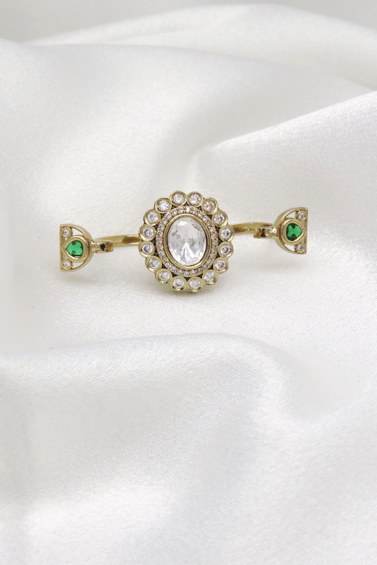 Distinctive CZ green multifinger ring with gold-toned detailing by joyrias