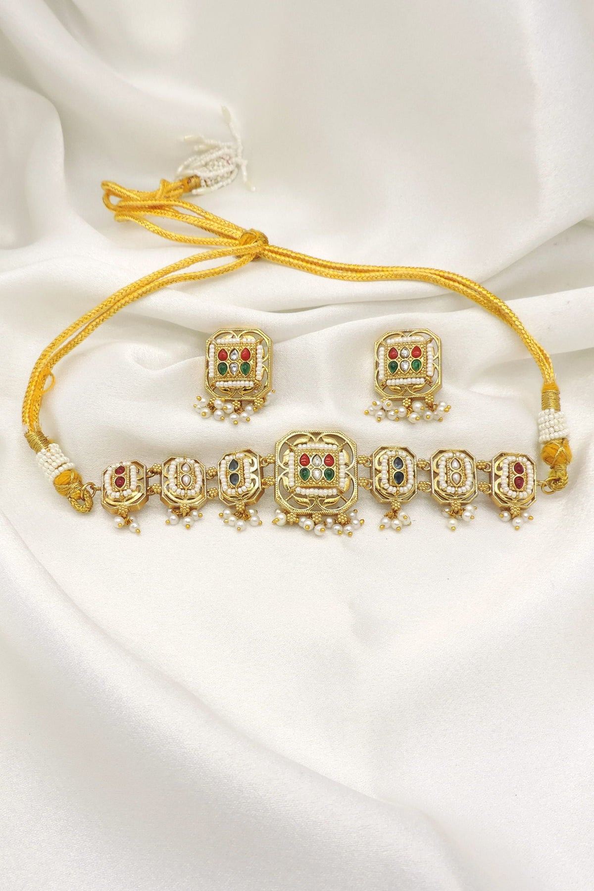 Gold-toned multicolor Kundan panel necklace set with pearl drops and matching earrings by joyrias