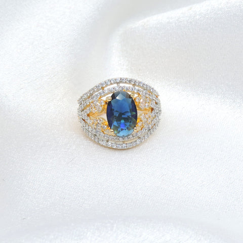 Brilliant blue stone CZ ring with gold-toned detailing by joyrias