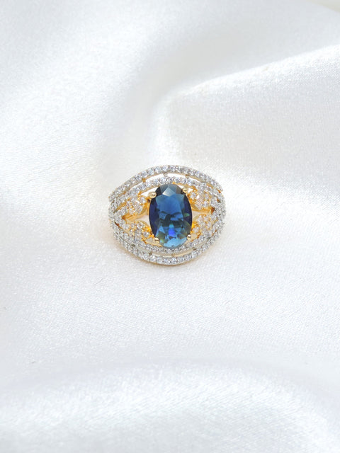 Brilliant blue stone CZ ring with gold-toned detailing by joyrias