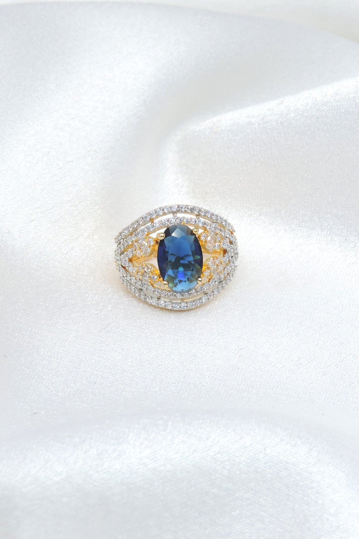Brilliant blue stone CZ ring with gold-toned detailing by joyrias