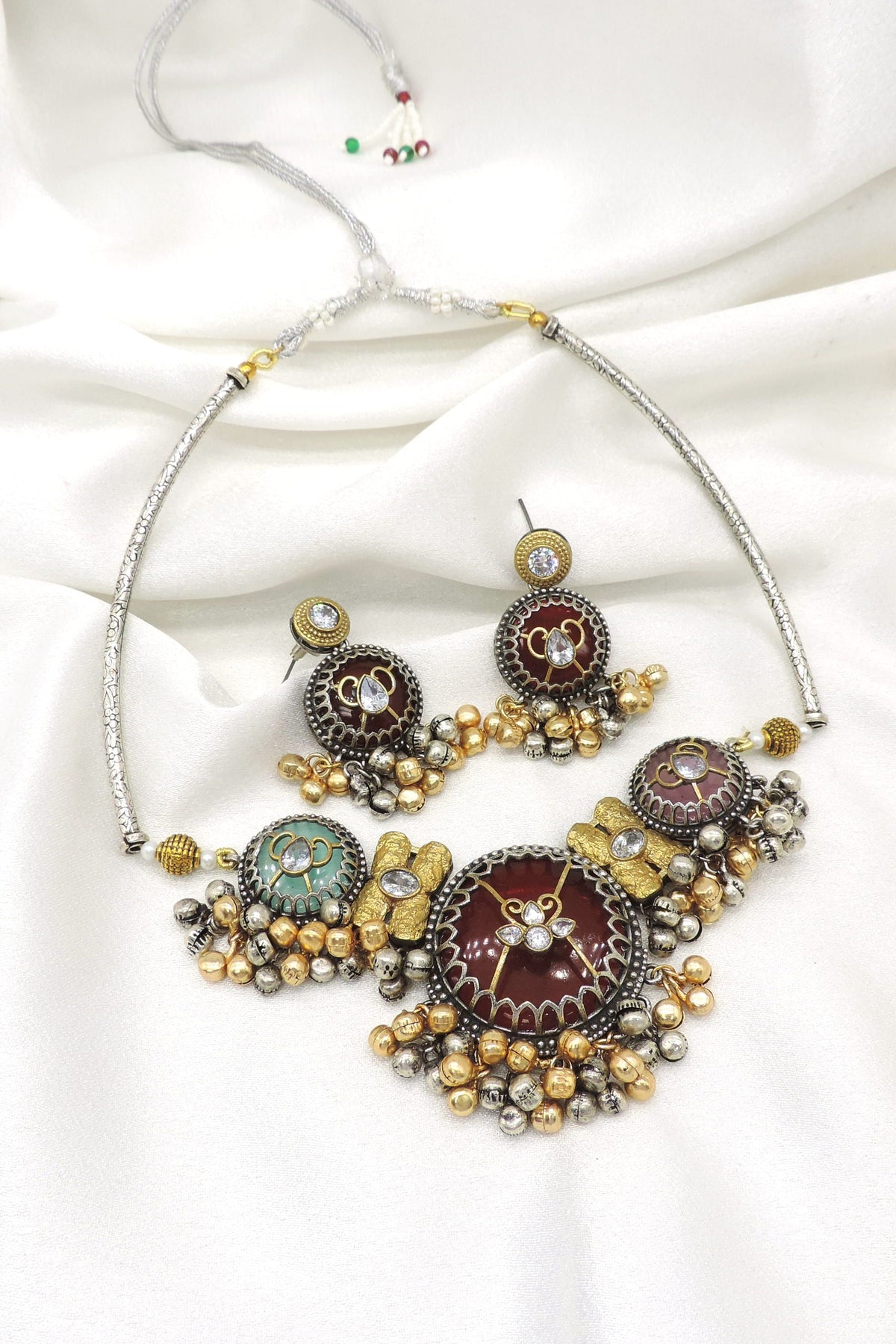 Oxidized dual-tone meenakari pearl necklace set with maroon and green detailing and matching earrings by joyrias